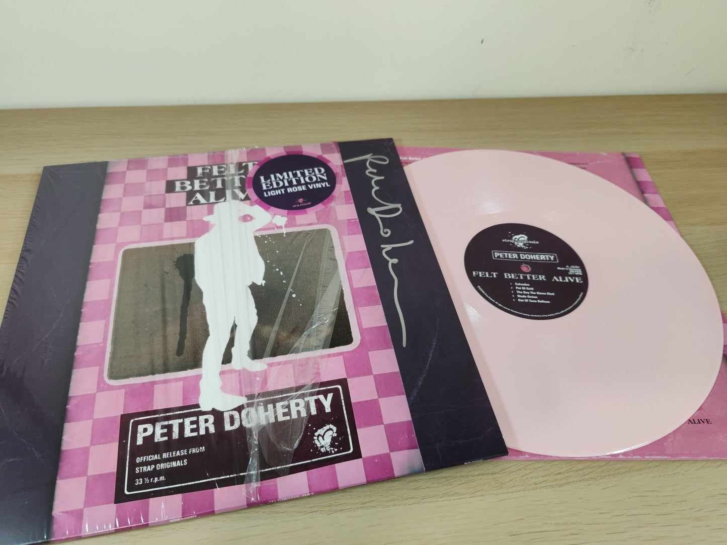 Peter Doherty’s “Felt Better Alive” light rose vinyl record in sleeve.