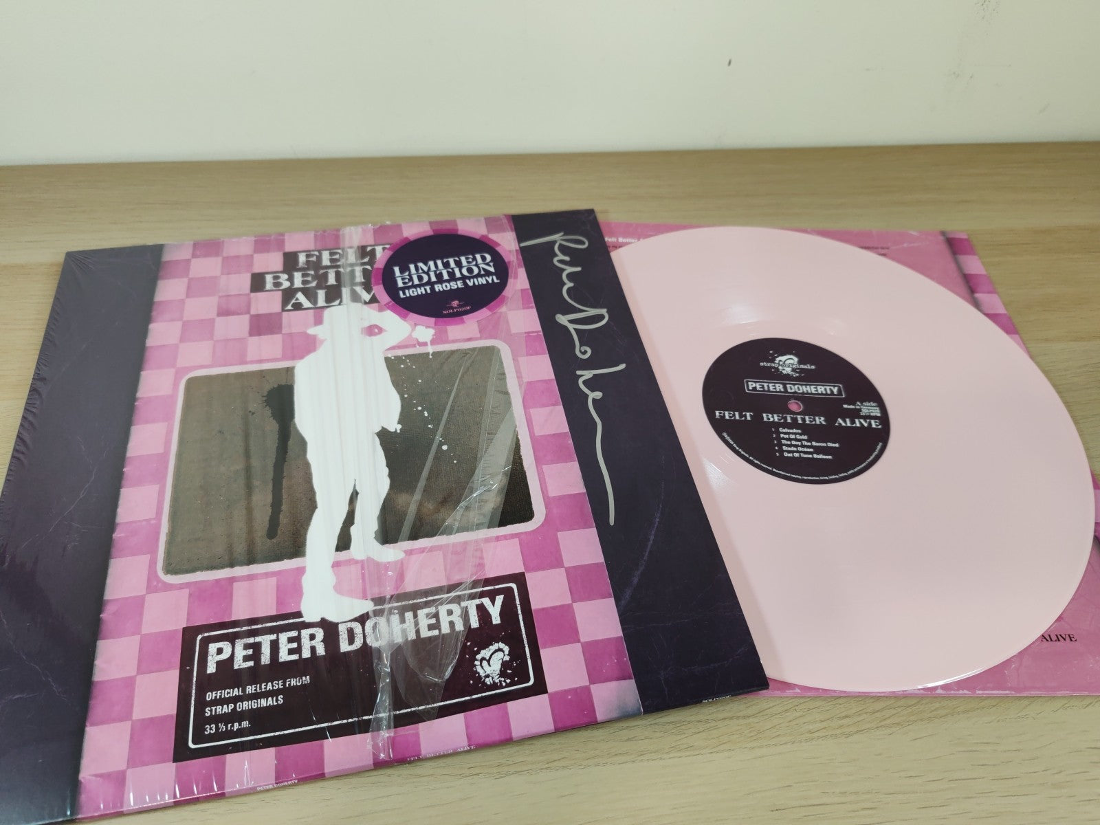 Peter Doherty’s “Felt Better Alive” light rose vinyl record in sleeve.