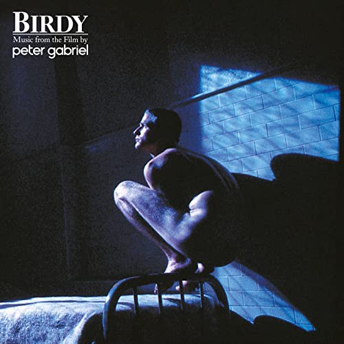 Peter Gabriel's "Birdy" vinyl album cover: a man crouched in a blue-toned room.