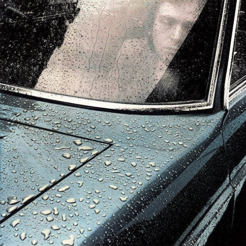 CD cover art: wet, dark car hood with a cloudy sky reflection.