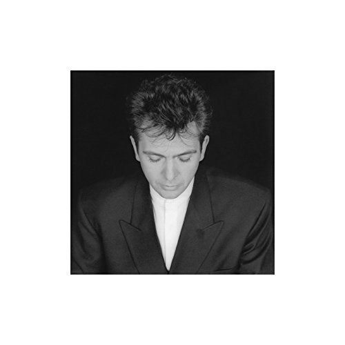 Black and white portrait of Peter Gabriel with his head bowed.