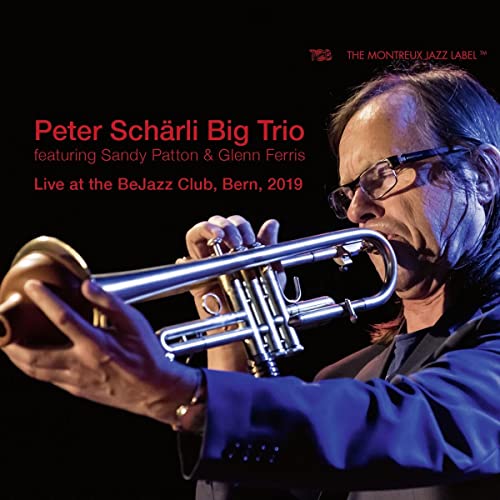 Jazz musician playing trumpet, album cover for Peter Schärli Big Trio.