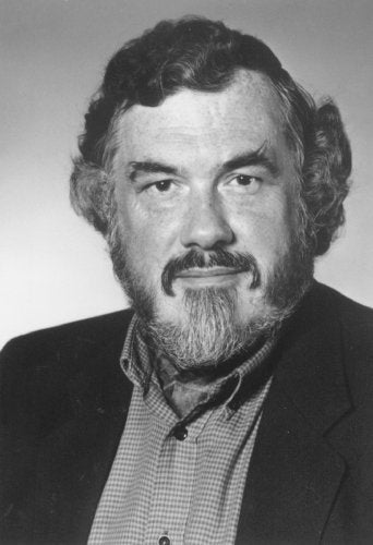 Black and white portrait of a bearded man with curly hair.