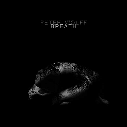 Dark album cover for "Breath" by Peter Wolff, featuring a cracked face.