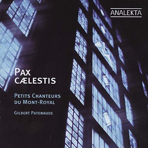 "CD cover with a dark building and lit windows, displaying white text."