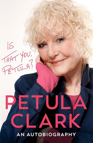 A portrait of Petula Clark with blonde curly hair, wearing a dark blue jacket.