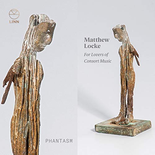 CD cover featuring two weathered, wooden figurative sculptures against a light background.