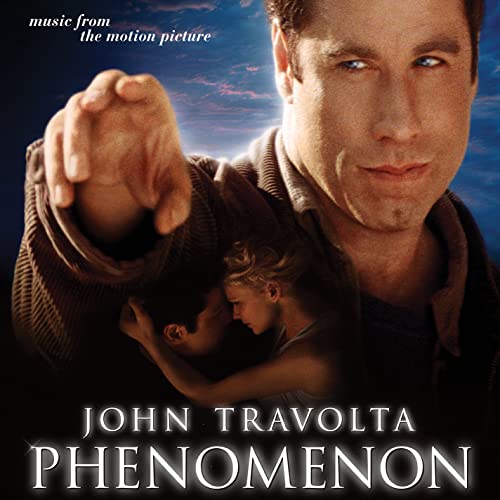 Album cover for "Phenomenon" featuring John Travolta and a young girl.