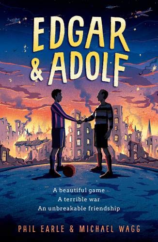 Two boys in soccer kits shake hands before a burning city at sunset.