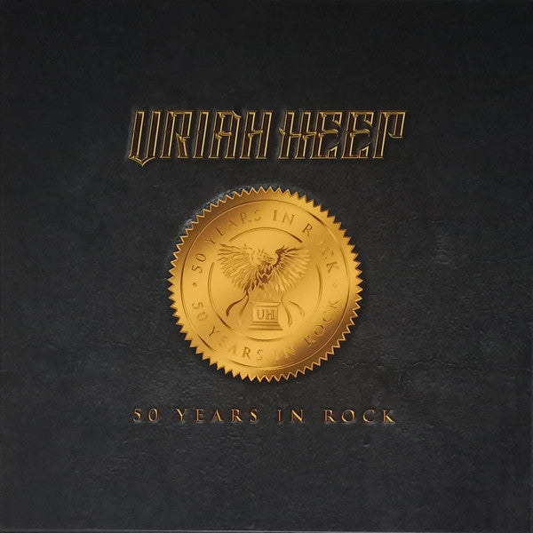 Black CD cover with gold lettering, a seal, and a bird emblem.