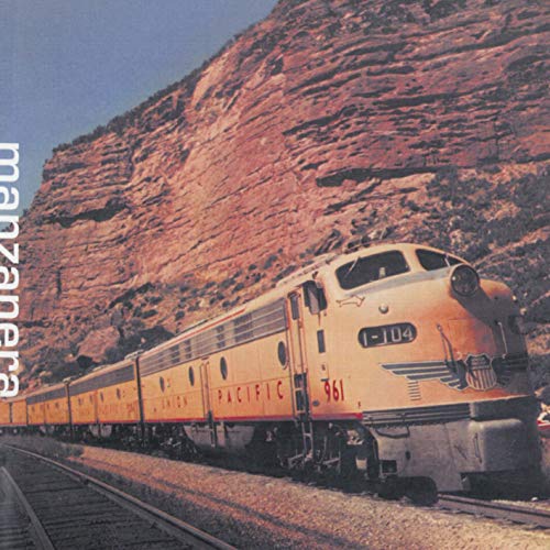 CD cover: Train travels through a canyon with red rock formations.
