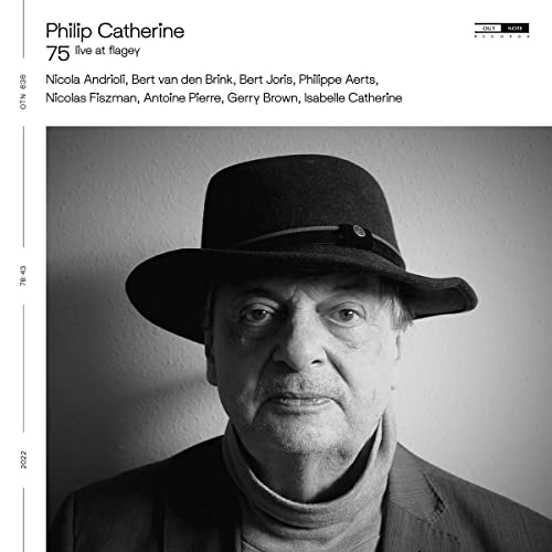 Black and white album cover featuring a man wearing a hat and turtleneck.
