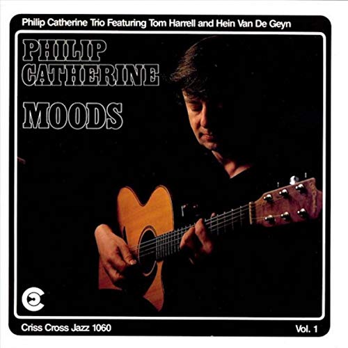 Album cover featuringCS showing a man playing an acoustic guitar against a dark background.