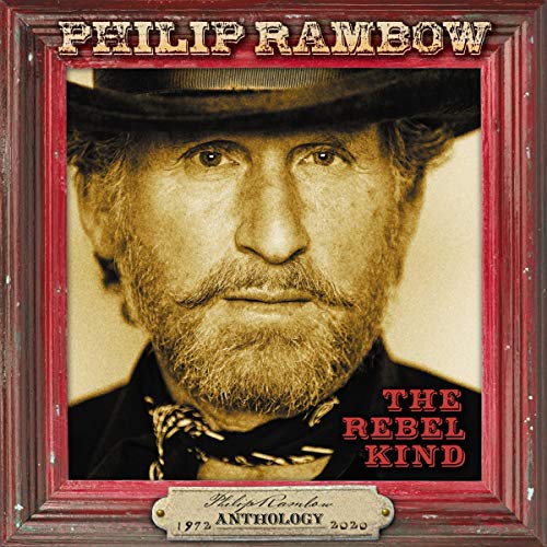 A framed sepia-toned portrait of a man with a hat and bandana.