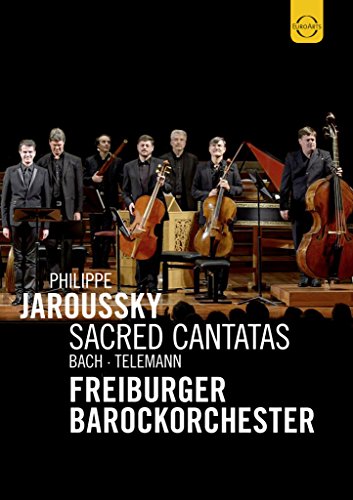 Orchestra performing with Philippe Jaroussky on a dark stage, DVD cover.