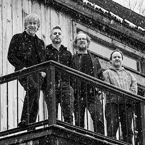Black and white photo of the band Phish standing on a porch.