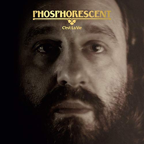 Close-up portrait of a bearded man with album title overlayed.