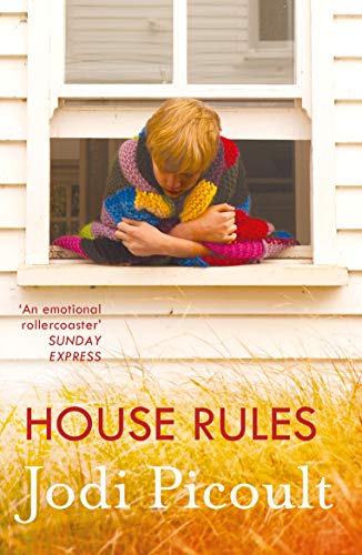 Book cover: child wrapped in a colorful quilt sits in a window.