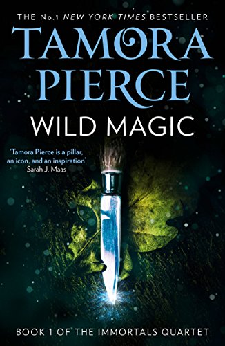 Book cover: “Wild Magic” by Tamora Pierce, featuring a dagger and face.