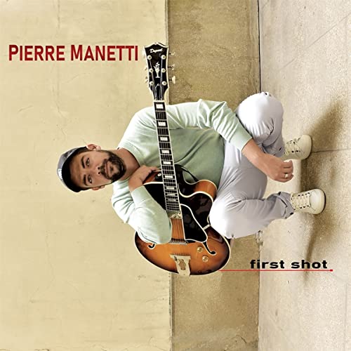 Manetti with a guitar, album cover for “First Shot” CD.