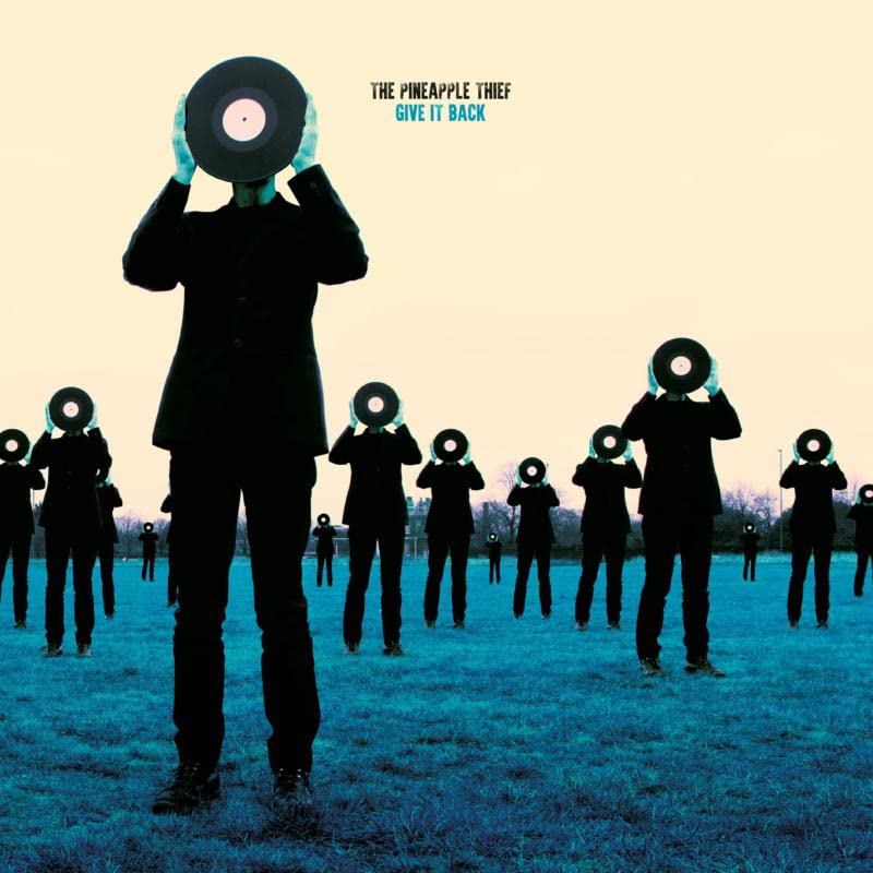 Silhouettes of people with vinyl records for heads in a field.