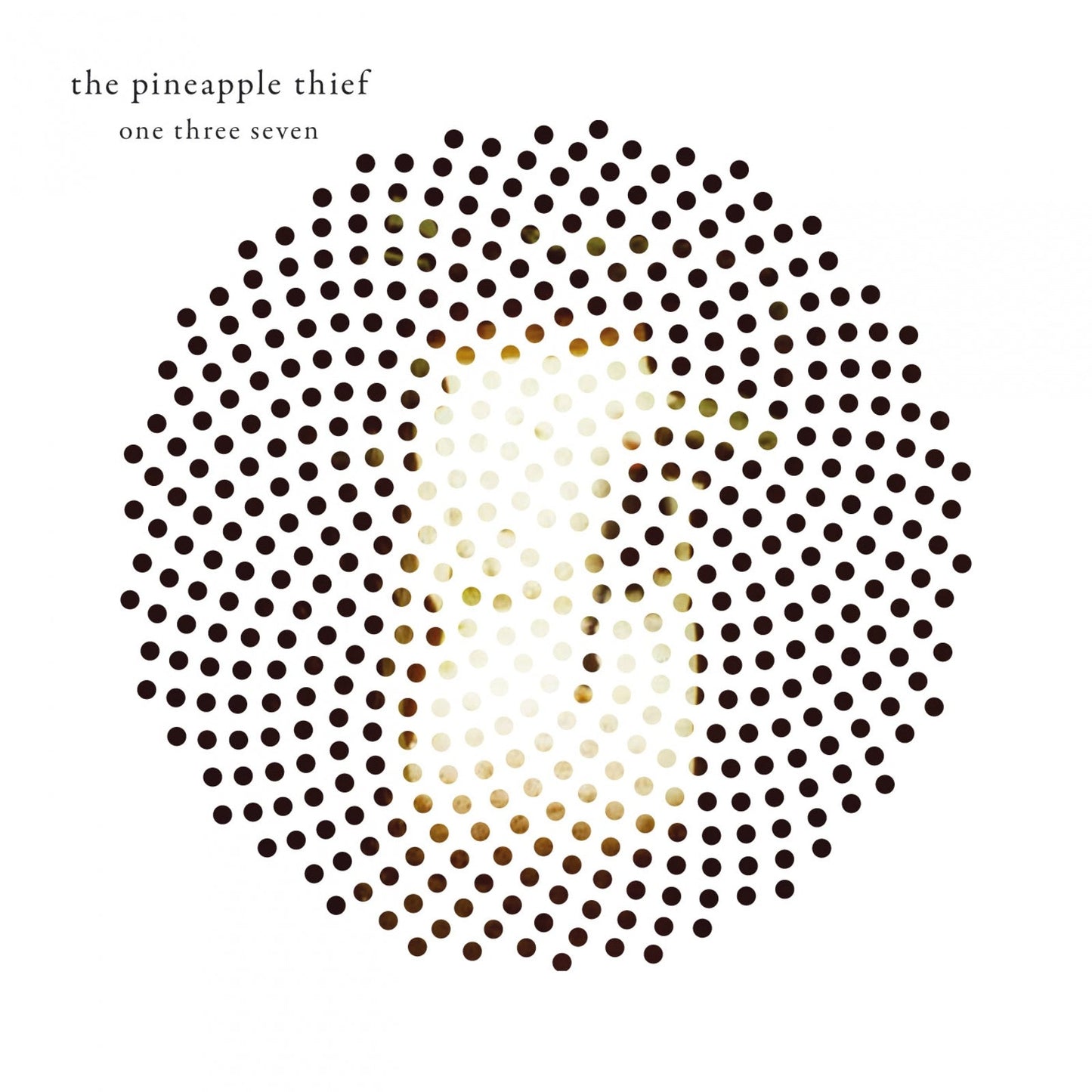 Album cover featuring a circular pattern of black dots obscuring a blurred human face.