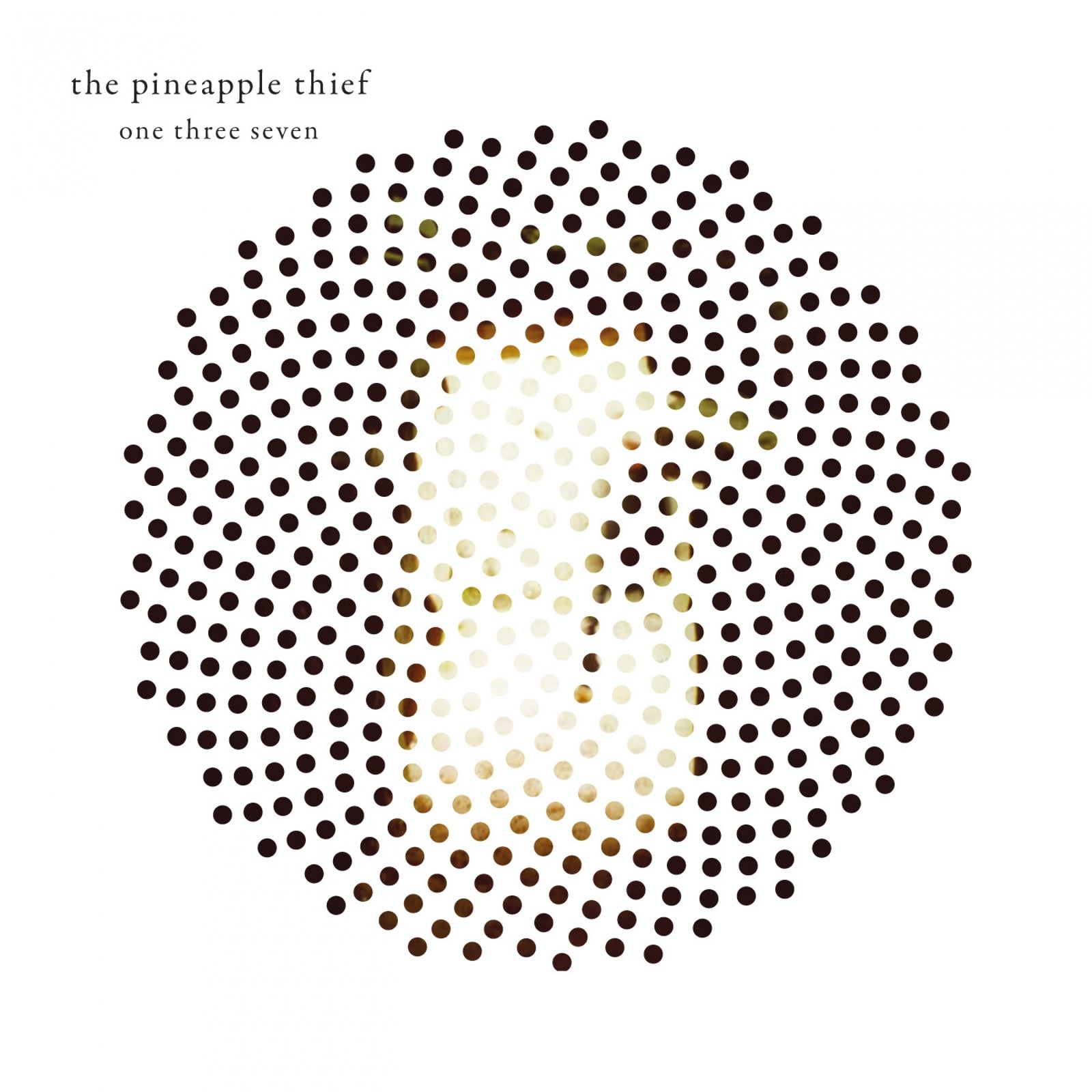 Album cover featuring a circular pattern of black dots obscuring a blurred human face.