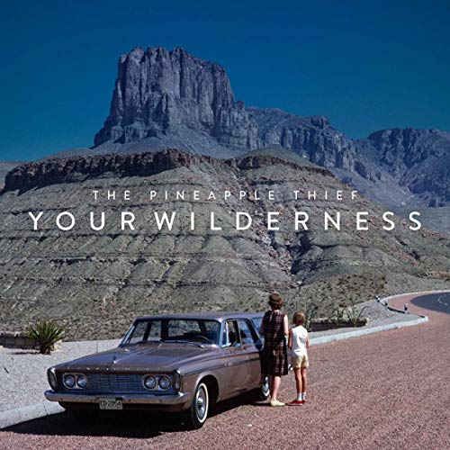 Album cover: mountains, a car, and two figures standing by the road.