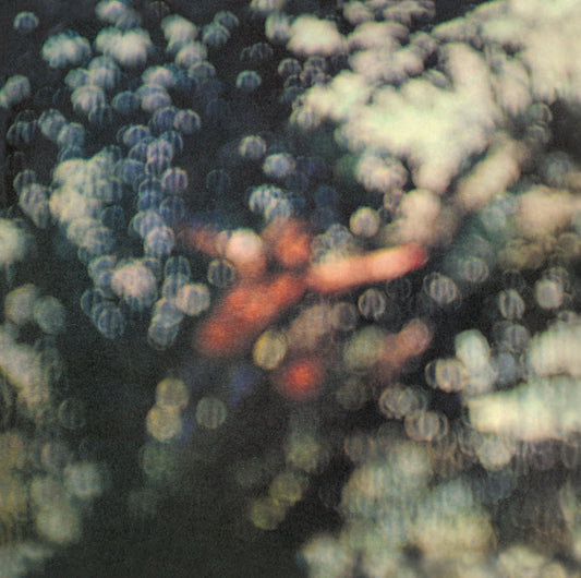 Blurred, out-of-focus image of a person’s face and hand amidst soft, glowing light orbs.