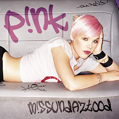 Pink album cover: artist with pink hair lying on a textured surface.