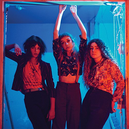 Three women standing together, illuminated by blue light, in a posed promotional photograph.