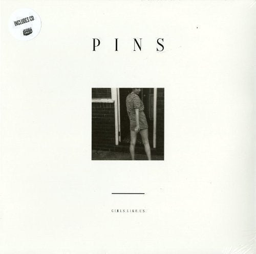 Vinyl record cover for Pins’ “Girls Like Us” featuring a black and white photo.