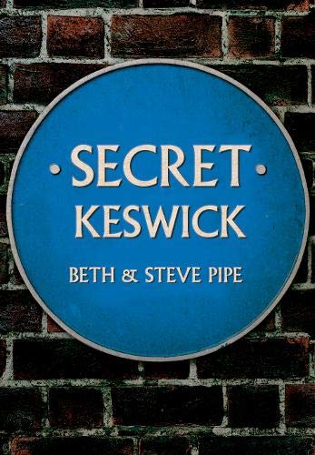 Round blue plaque reading "Secret Keswick" against a brick wall.