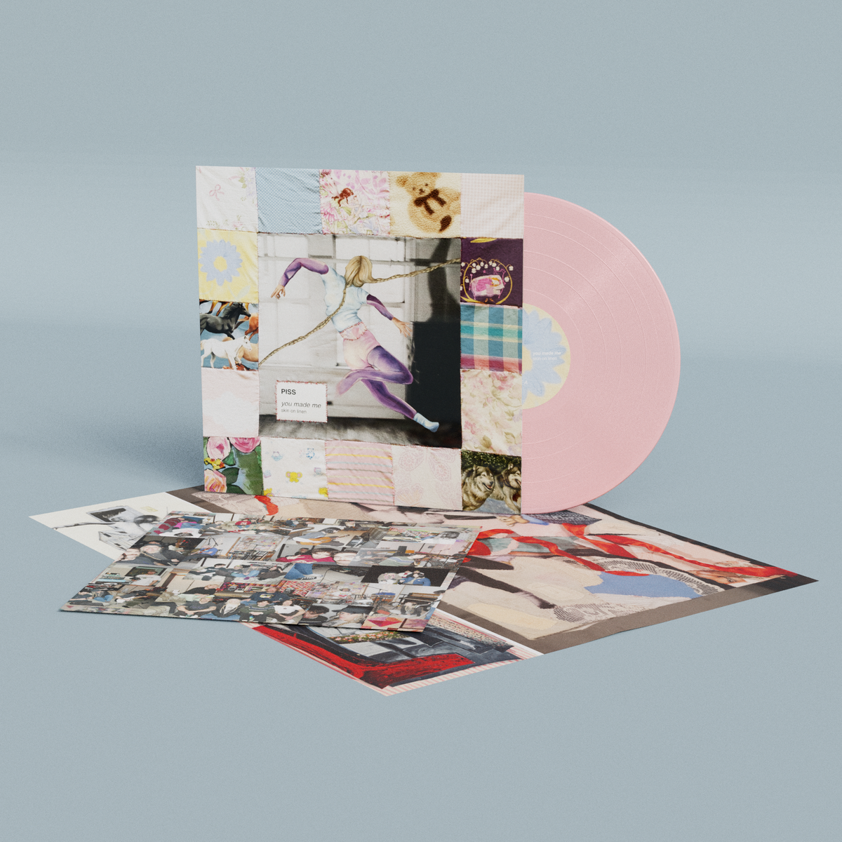 Pink vinyl LP with collage-style album cover and accompanying inserts.