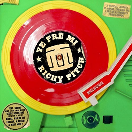 Red vinyl record with yellow rim and black label on green background with CD.