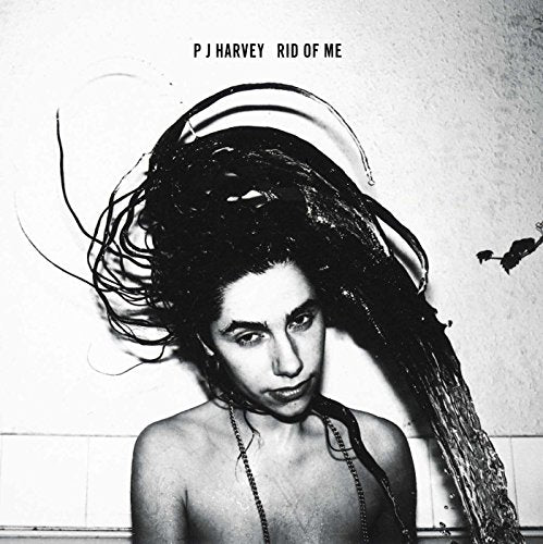 Black and white album cover featuring PJ Harvey with wet, disheveled hair.