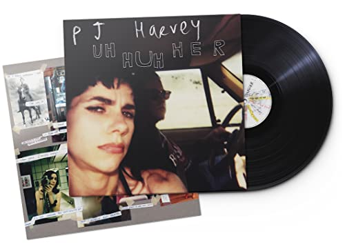 PJ Harvey’s “Uh Huh Her” vinyl record with album cover and inserts.