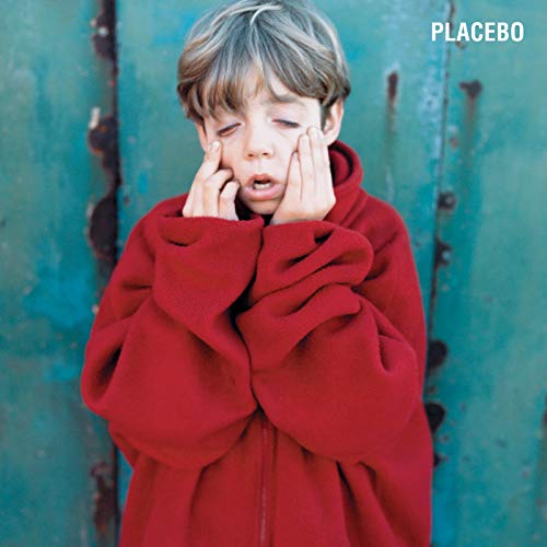 The alt text for the image is: "Young boy in red hoodie covering his face, 'PLACEBO' text".