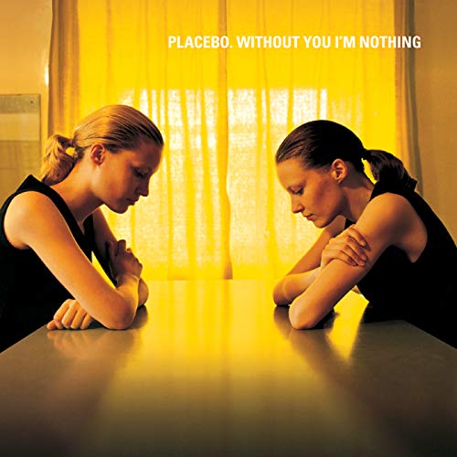 "Album cover with two women in black leaning on a table, text 'Placebo. Without You I'm Nothing'."