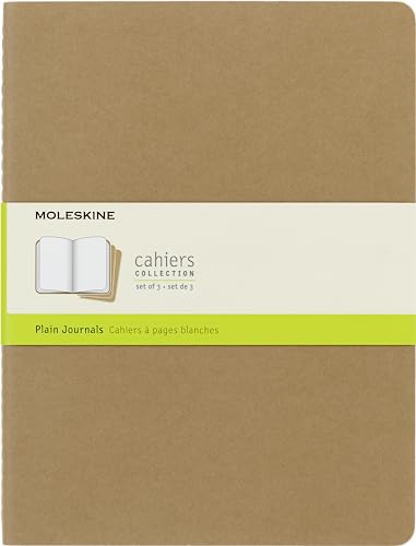 A tan Moleskine Cahier journal with a branded paper band across the center.