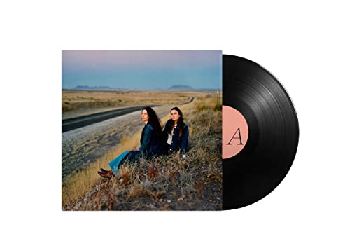Vinyl record with album cover featuring two women by a road.