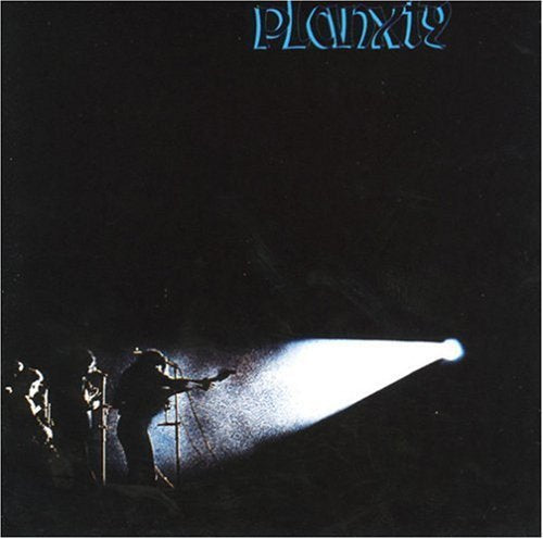 Album cover with silhouetted musicians on stage, spotlight shining, against a black background.