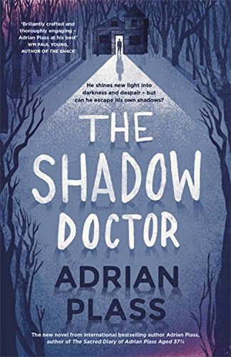 Book cover for “The Shadow Doctor” depicts a cabin illuminated by a beam of light.