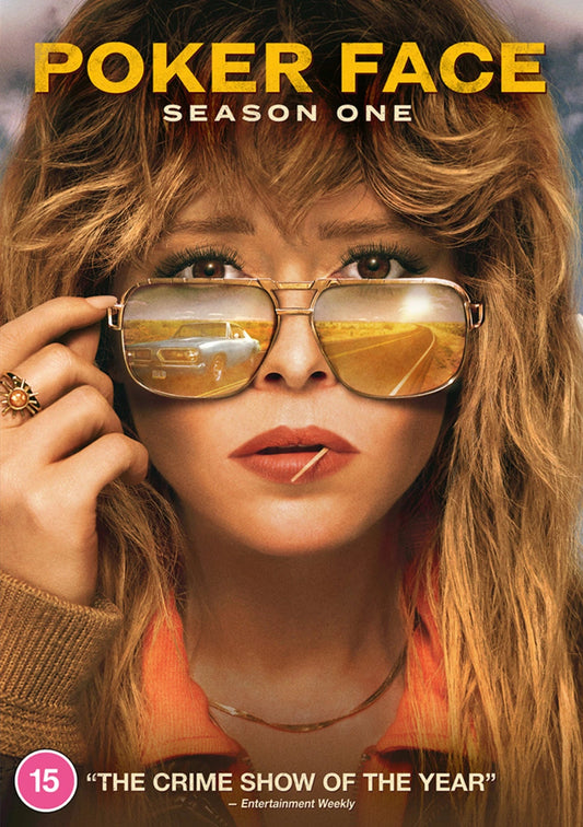 Close-up of a woman wearing sunglasses reflecting a car on a desert road.