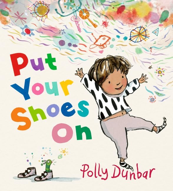 A child in a polka-dot shirt dances near a pair of shoes and drawings.