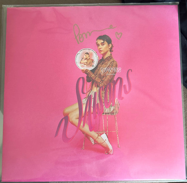 Pink vinyl record cover featuring a portrait of a woman with fruit.