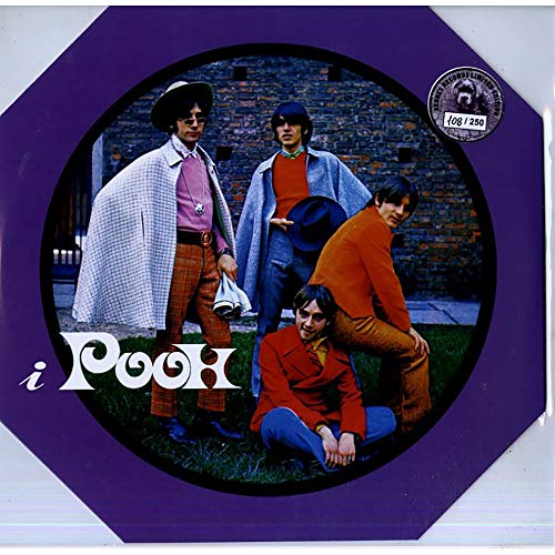 1970s band Pooh posing in colorful clothing against a brick wall.