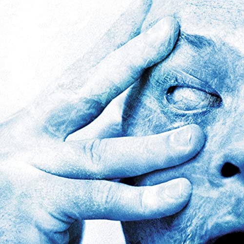 Close-up of a hand touching a face in a blue-tinted, high-contrast photographic style.