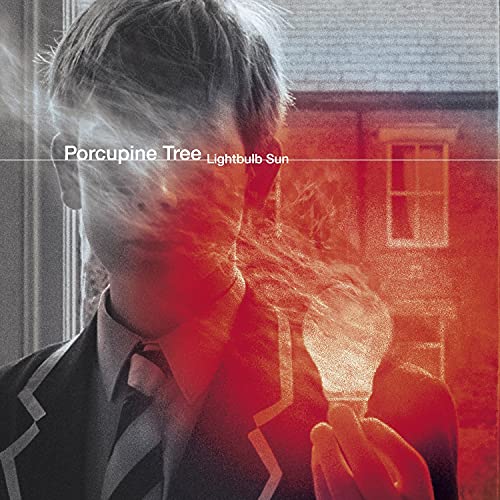 Album cover showing a person in a school blazer holding a glowing lightbulb.