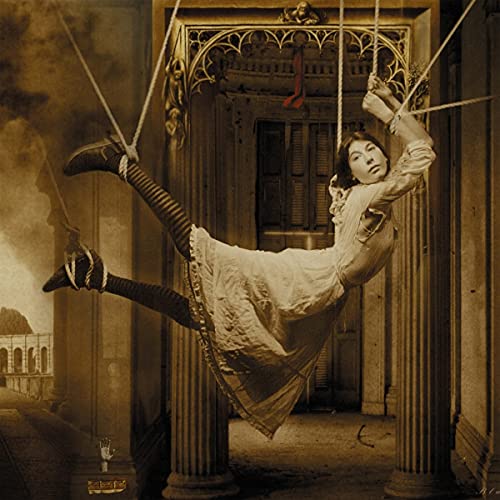 A woman in a white dress suspended by ropes in a sepia-toned architectural setting.